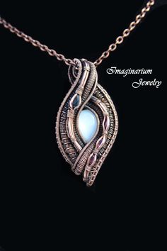 "This spectacular pendant has contributed to the winning of several awards at art festivals. The central stone is a natural white shimmering moonstone and it is accented to the left by a large teardrop blue sapphire and to the right by three sparkling oval pink tourmalines. The pendant is made by creating a frame and then attaching sections of wire that have been wrapped and woven together. It includes a textured 28\" solid copper chain. The copper has been coated with an anti-tarnish sealant to Wire Wrapped Stone Jewelry, Wire Wrap Jewelry Designs, Diy Jewelry Inspiration, Wire Jewelry Designs, Oxidized Copper, Wire Wrapping Stones, Hand Bracelet, White Moonstone, Jewelry Wire