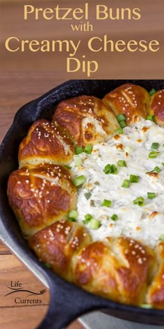 a cheesy dip in a cast iron skillet with the words pretzel buns with creamy cheese dip