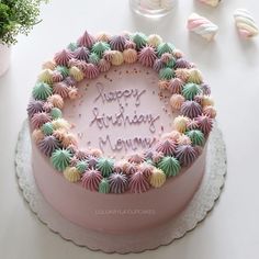 a birthday cake with the words happy birthday mom written in frosting surrounded by seashells