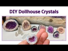 a person holding some kind of rock with other rocks around it and the words diy dollhouse crystals