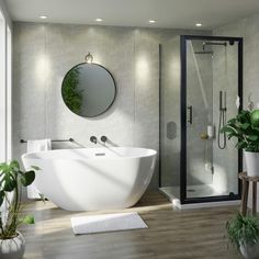 a white bath tub sitting next to a shower in a bathroom under a round mirror