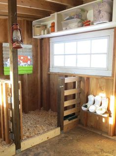 the inside of a small wooden house with lots of wood shavings on the floor