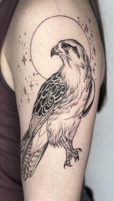 a woman's arm with an eagle and the moon on it, done in black ink