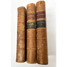 three old books sitting on top of each other