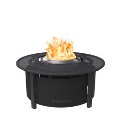 a black fire pit sitting on top of a white surface with flames coming out of it