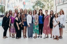 a group of women standing next to each other