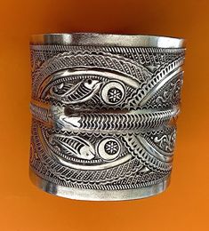 "Presenting a wonderful vintage, solid silver cuff BRACELET from Tunisia. The bracelet measures over 2 1/2\" (6,45 cm) wide and its inner diameter is 2 3/4\" (7,0 cm), though it is FULLY ADJUSTABLE. The bracelet features wonderfully textured floral and geometric designs. It has Tunisian and Libyan hallmarks for 800 silver. This piece is also an excellent size for a man's wrist." Traditional Handmade Wide Band Jewelry, Traditional Handmade Jewelry With Wide Band, Traditional Silver Wide Band Jewelry, Traditional Filigree Cuff Bracelet Bangle, Traditional Filigree Cuff Bangle Bracelet, Ornate Cuff Bracelet For Ceremonial Festivals, Unique Filigree Bangle Cuff Bracelet, Ornate Handmade Ceremonial Cuff Bracelet, Unique Antique Silver Cuff Bracelet With Intricate Design