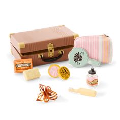 an assortment of travel items including a suitcase, hair brush, and other things on a white background