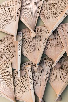 many wooden fan shaped objects are arranged together