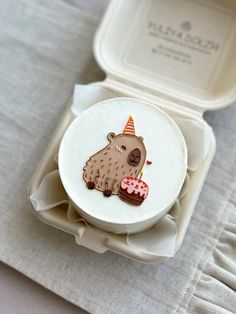 a cake in a box with a bear on it