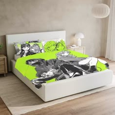 a bed with green sheets and black and white designs on the comforter, along with two nightstands