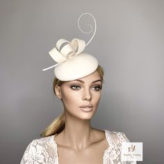 Ivory cocktail hat hand blocked on a button shape wood hat block, made with wool felt and trimmed whith a ostrich spine and a felt bow in Kate Middleton Style. This hat is perfect for winter races, christmas parties, weddings or any special occasion. It is mounted on a elastic . Follow this link for more beautiful choices from 'Sophie Young Hats' https://www.etsy.com/shop/sophieyounghats White Fascinator For Kentucky Derby Gift, White Mini Hats For Royal Ascot, Elegant White Hat For Gift, Formal Cream Mini Hat With Curved Brim, Formal Cream Headpiece With Short Brim, Elegant Fascinator With Pinched Crown For Gift, Elegant Pinched Crown Fascinator Gift, Chic Cream Fascinator For Wedding, Elegant Cream Fascinator For Kentucky Derby