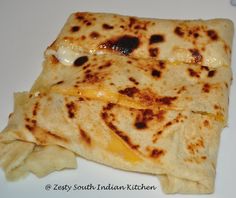 two pieces of flat bread on a white plate