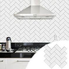 a kitchen with black counter tops and white tile backsplashes on the wall