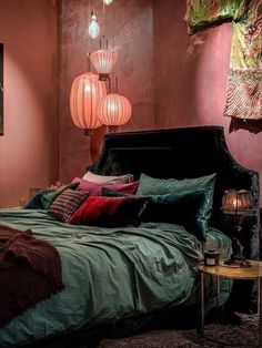 a bed sitting in a bedroom next to two lamps