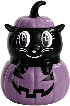 a black cat sitting on top of a purple pumpkin shaped container with eyes and ears