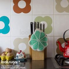 there is a tea pot on the counter next to other kitchen utensils and dishes