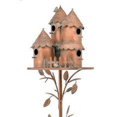 a metal bird house with three birds perched on it's roof and two trees growing out of the top