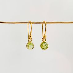 Add some subtle but noticeable color to your everyday look with these exquisite Bezel Gemstone Drop Earrings! Featuring petite faceted gemstones bezel-set and suspended from gold-filled ear wires, you can find the perfect birthstone for you or someone special in the twelve birthstones of the year. An ideal personalized gift for any occasion! -- bezel charm: 6mm French hook ear wires 14k gold filled Dainty 14k Gold Filled Birthstone Earrings, Delicate Faceted Gold Earrings, Gold Dangle Earrings With Bezel Setting, Dainty Faceted Everyday Earrings, Gold Bezel-set Dangle Earrings, Dainty May Birthstone Earrings, Dainty Earrings With Bezel Setting For Gift, Dainty Bezel Set Earrings For Gift, Gift Dangle Earrings With Bezel Setting