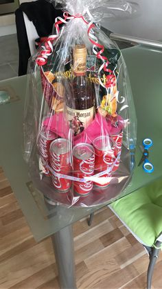 a table topped with a basket filled with drinks and condiments on top of it