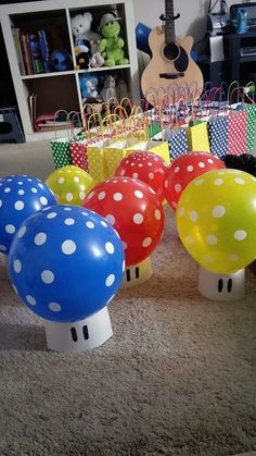 there are many balloons in the shape of mushrooms on the floor next to each other