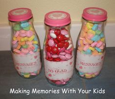 three glass jars filled with candy and hearts