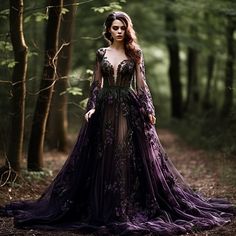 a woman is standing in the woods wearing a purple dress with sheer sleeves and flowers on it