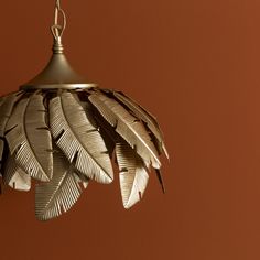 a light that has some kind of bird feathers hanging from it's ceiling fixture