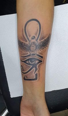 a person with a tattoo on their arm and an eye in the middle of it