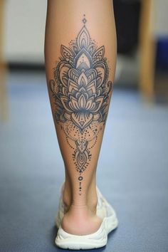 a woman's leg with a flower tattoo on it