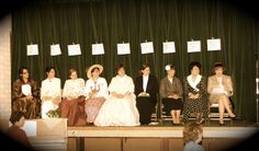 a group of people sitting on top of a stage