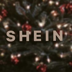 a christmas tree with the words shein in front of it and lights around it