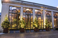 the building has many windows and plants in them