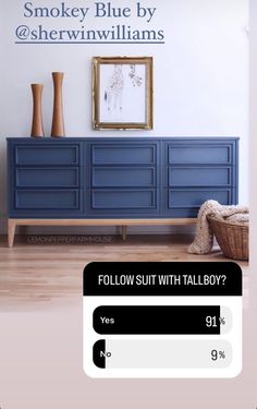 a blue dresser sitting next to a white wall