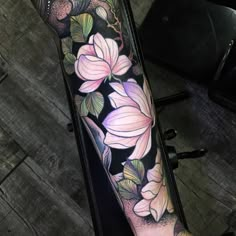 a woman's arm with flowers on it