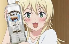 a woman holding up a bottle of vodka in front of her face with an animal on it