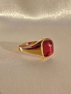 Antique 18k yellow gold ring from the United Kingdom. This signet ring features a vibrant synthetic ruby cabochon. Great antique condition Size: 7.5 resizable* Weight: 3.5 grams Band: 11.1 mm (front), 1.7 mm (back) Synth Ruby: 8.3 mm x 10.0 mm Hallmarks:18CT Luxury Blue Cabochon Signet Ring, 18k Yellow Gold Ring, Yellow Gold Ring, Signet Ring, Yellow Gold Rings, Gold Ring, United Kingdom, Gold Rings, Ruby