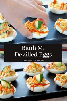 deviled eggs stuffed with cheese and vegetables are on a black tray, being held by a hand