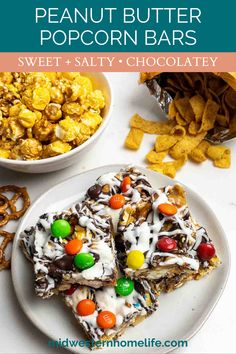 a plate topped with candy bar bars next to a bowl of cereal