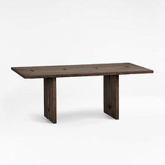 a wooden table sitting on top of a white floor