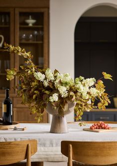 a vase filled with flowers sitting on top of a table