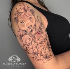 a woman with a lion and cubs tattoo on her arm is posing for the camera