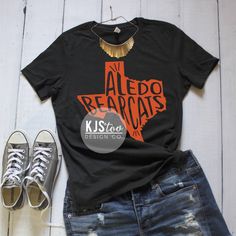 "Aledo Bearcats Tee - Aledo TShirt - Bearcats Shirt - Orange and Black Aledo Tee - Aledo Football Tee - Custom Highschool Tee - School Tee {$25} Before completing your purchase, please refer to our \"Shop Announcement\" and \"Shop Policies\" sections for important information, FAQ's, current turnaround times and upcoming closing dates. SIZING AND COLOR INFORMATION -We use UNISEX sizing for all our shirts, which means they run longer and looser than your typical women's tee. -If you prefer a more Black Relaxed Fit T-shirt With School Spirit, Black Casual T-shirt For School, Black T-shirt With Sublimation Print For School, Black T-shirt With Screen Print For School, Black Screen Print T-shirt For School, Casual Fitted T-shirt With Team Name, Black Relaxed Fit School Spirit T-shirt, Black Relaxed Fit T-shirt For School Spirit, Black Relaxed Fit Tops For School