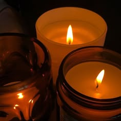 three lit candles sitting next to each other