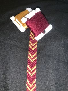 a knitted tie with a toy car attached to it