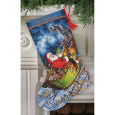 a christmas stocking hanging from a mantel decorated with santa's sleigh