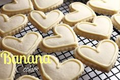 several heart shaped cookies on a cooling rack with the words banana cookies written above them