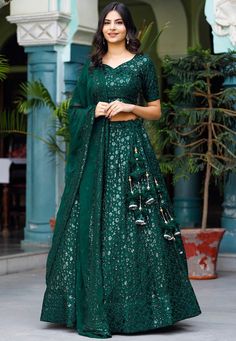 Readymade Faux Georgette Lehenga in Dark Green. This attire with Cotton and Shantoon Lining is Enhanced with Enhanced with Fancy Tassels, Resham and Sequins Work Available with a Faux Georgette Dark Green Choli Crafted in Sweetheart Neck and Half Sleeves and a Faux Georgette Dupatta in Dark Green. The Choli and Lehenga Lengths are 15 and 42 inches respectively Do Note: Accessories shown in the image are for presentation purposes only. (Slight variation in actual color vs. image is possible). We Embroidered Lehenga For Party Festivities, Embroidered Lehenga For Festive Party Occasions, Green Embroidered Party Wear Sets, Embroidered Lehenga For Party And Festive Season, Festive Embroidered Party Lehenga, Green Embroidered Lehenga For Party, Embroidered Green Lehenga For Party Wear, Green Sequined Sets For Navratri, Traditional Fitted Sequin Fabric For Navratri