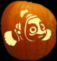 a pumpkin with an image of a fish carved on it's face and eyes