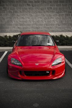 a red sports car parked in a parking lot